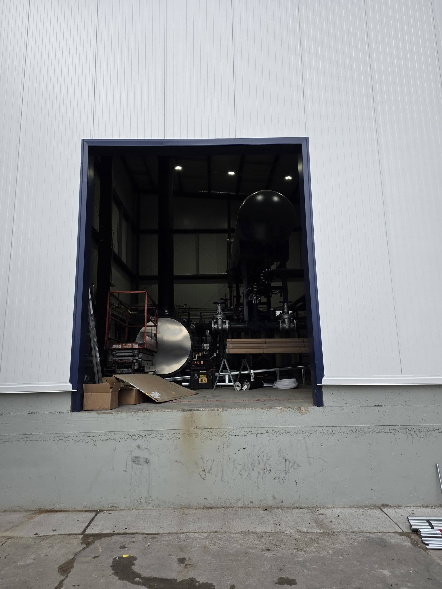 Commercial building with open doorway before garage door installation