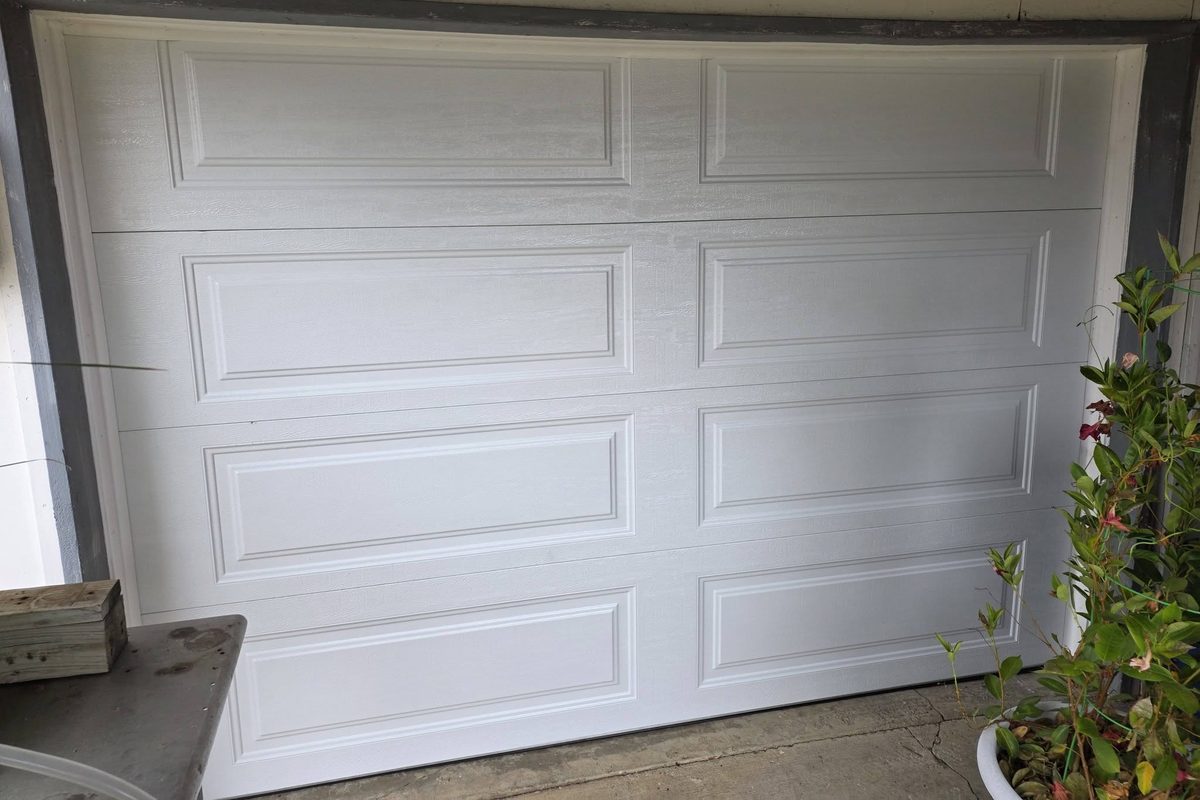 New white raised-panel garage door installed by American Standard Garage Door