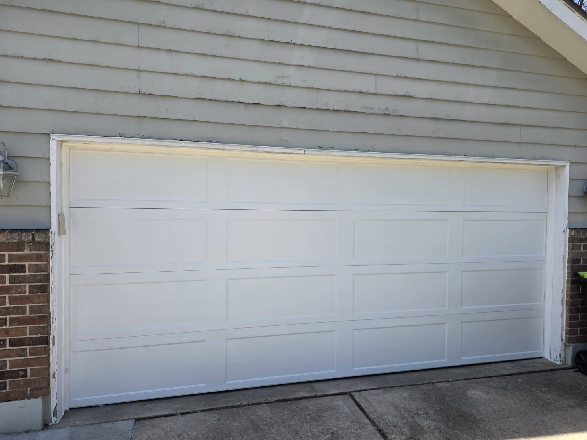 Brand new white garage door installed by American Standard Garage Door KC