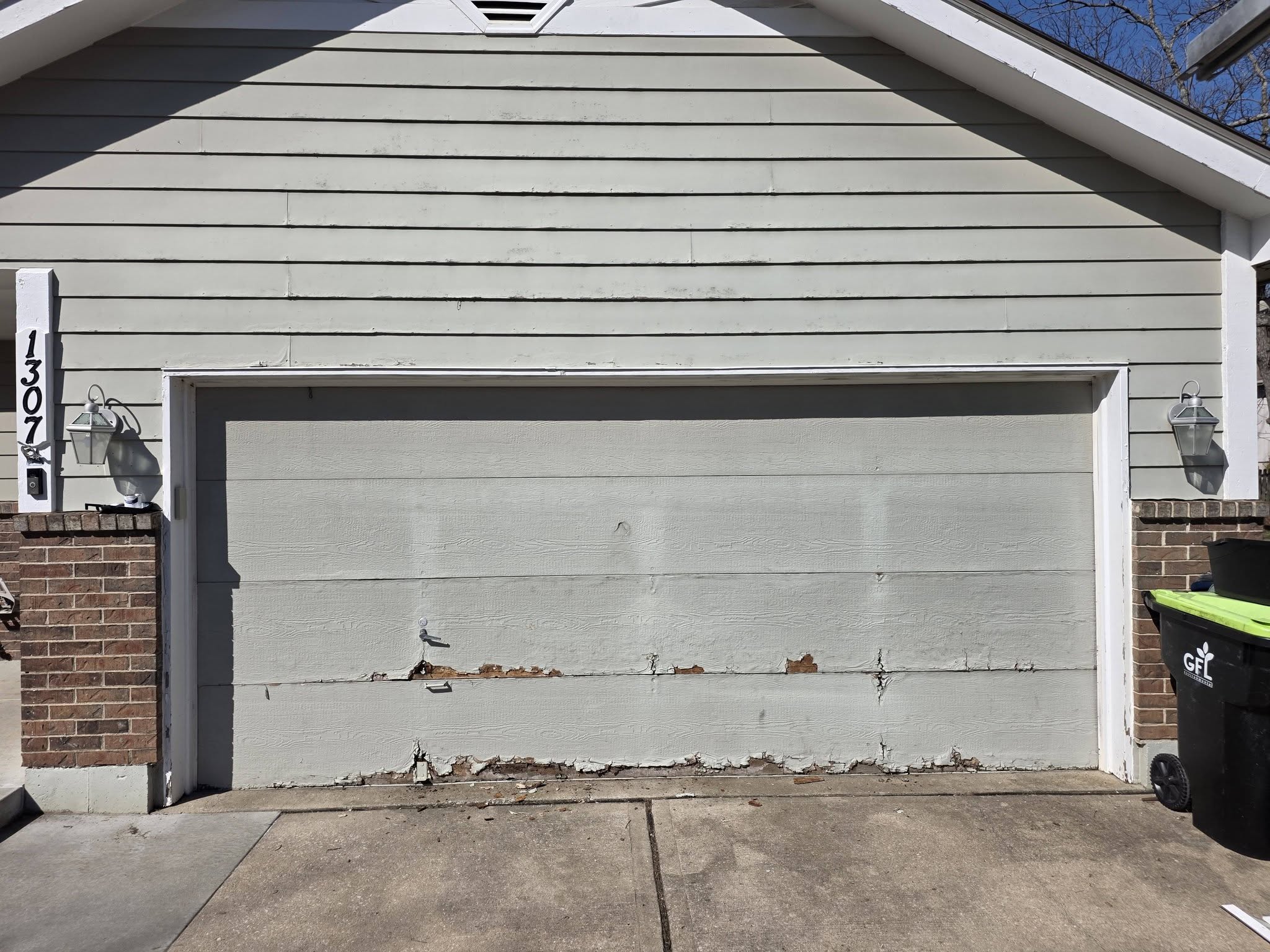 Rotting deteriorated garage door before replacement in Kansas City