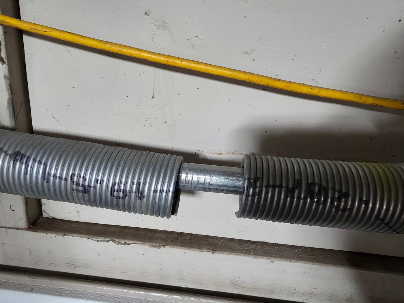 Close-up of torsion springs on a garage door shaft
