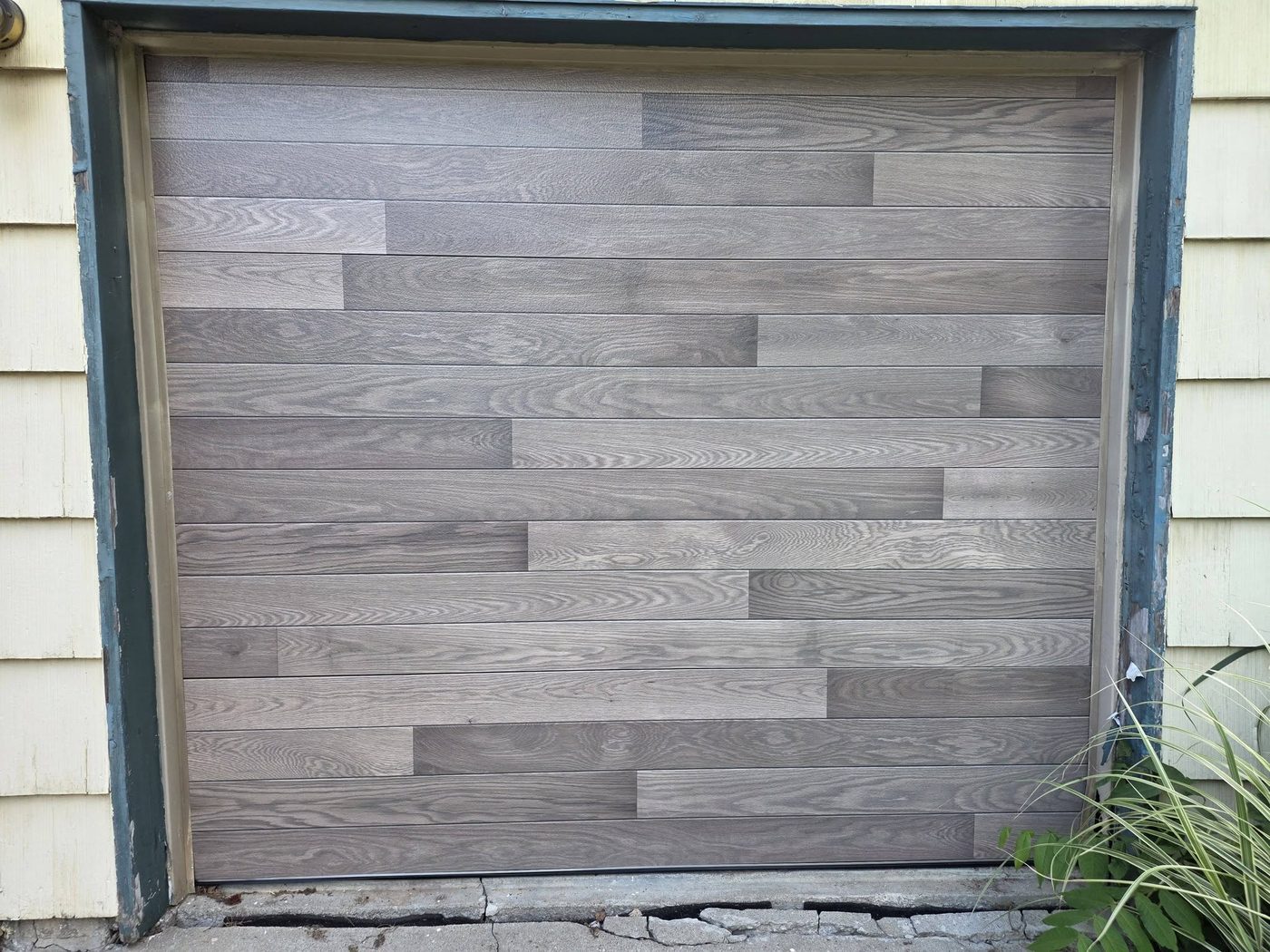 Wood-look horizontal plank garage door installed by Zach