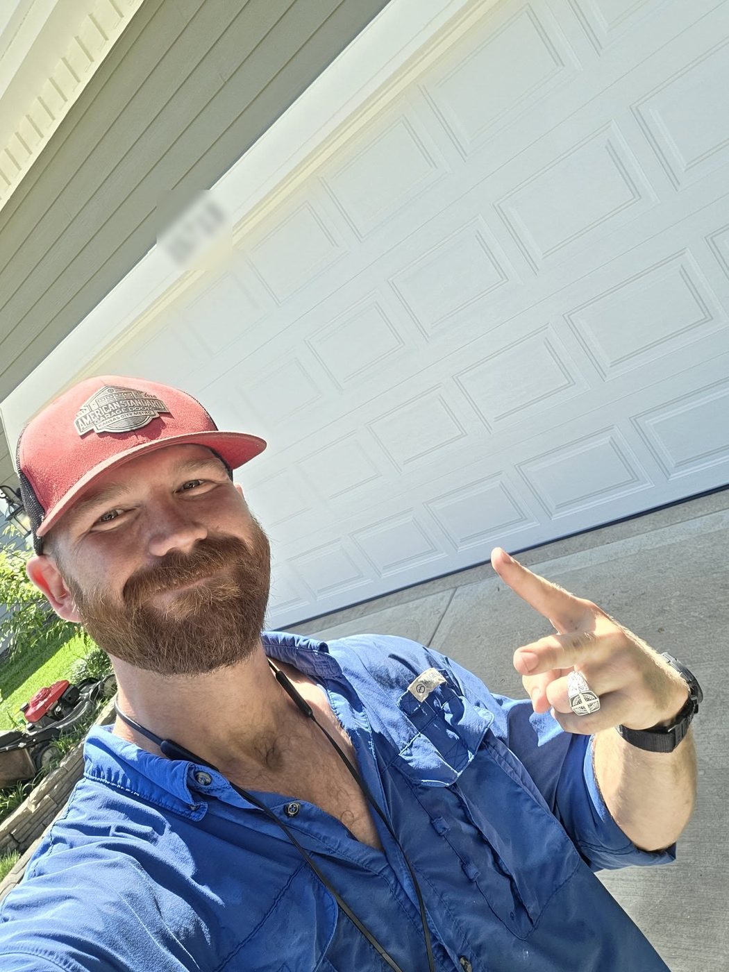 Zach Wallace on a job in front of a white garage door
