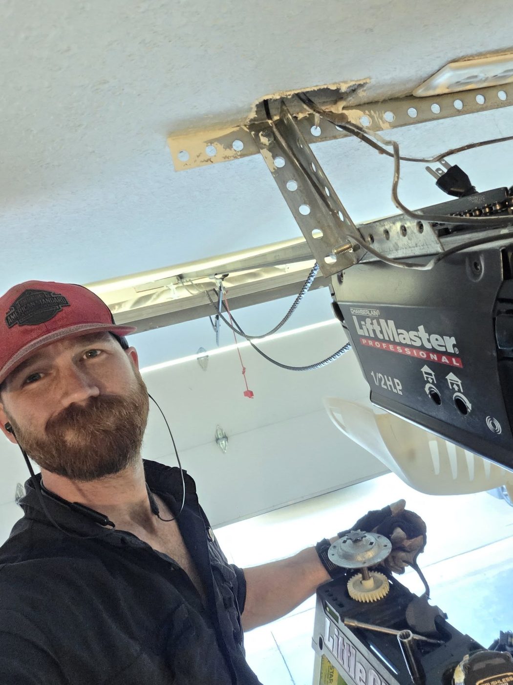 Zach Wallace mounting a LiftMaster opener