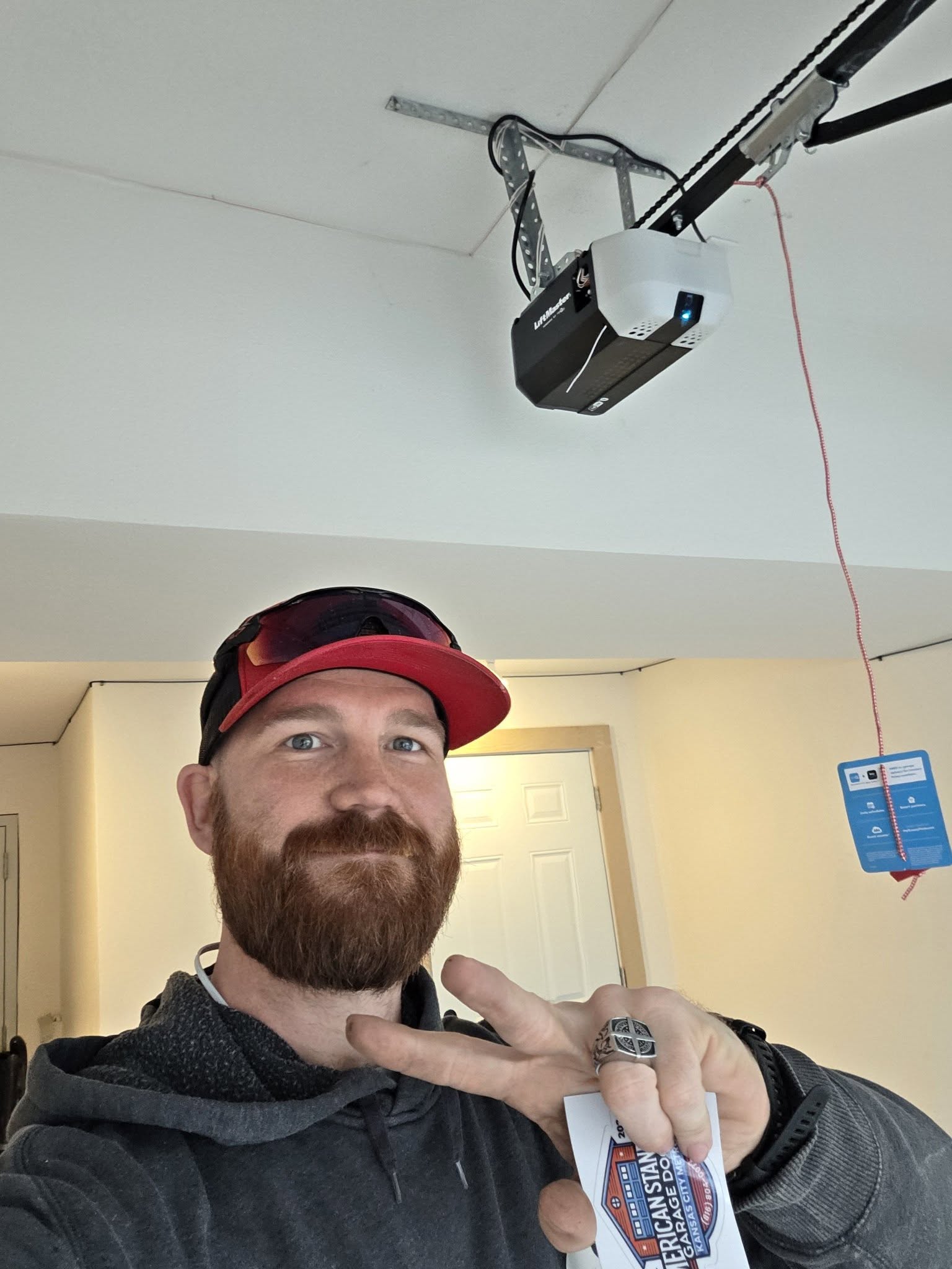 Zach Wallace showing completed LiftMaster opener installation